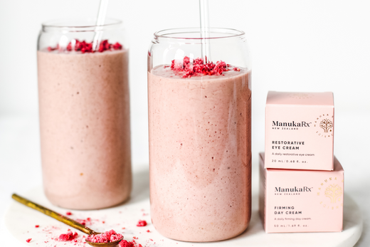 Pink smoothie next to ManukaRx skincare